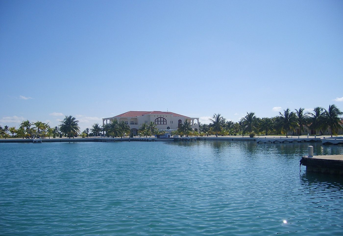 The marina and a pastel clubhouse on Caye Chapel, Belize, seen from the water