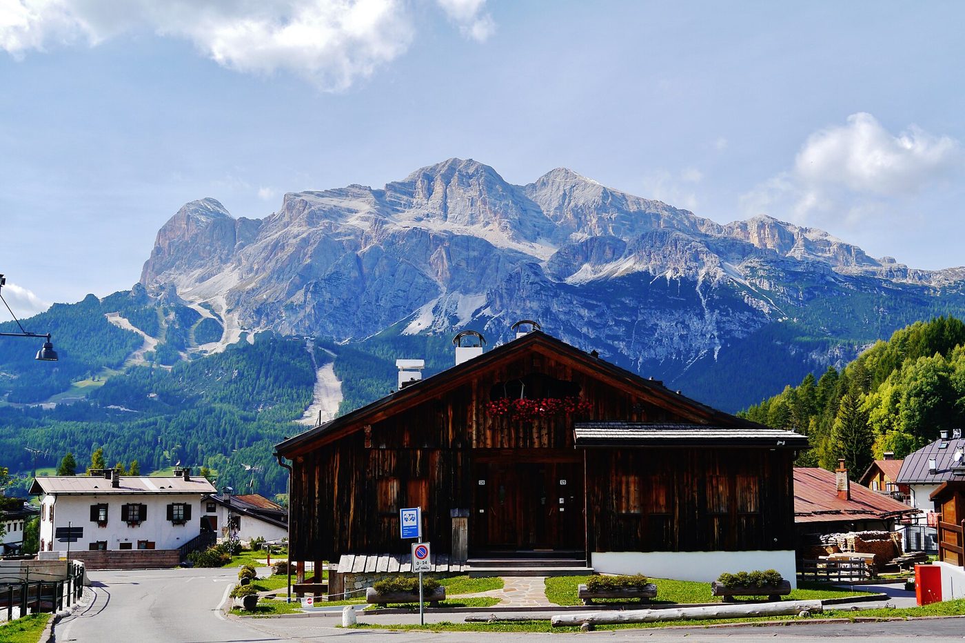 A wooden chalet in Cortina d'Ampezzo with the Dolomites behind